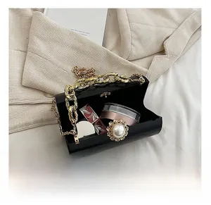 Internal capacity of black patent leather bucket bag with gold chain and pearl buckle