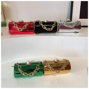 Detailed view of five metallic cylinder evening bags with pearl and crystal top clasps