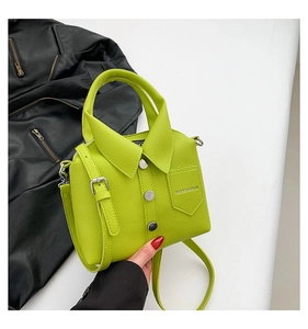 Detail of neon green shirt-shaped bag with decorative buttons and leather texture