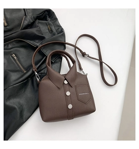 Detail of creative shirt-shaped crossbody bag with white buttons and fashion text