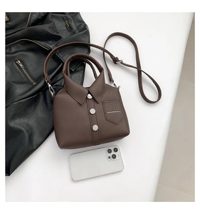 Top-down view of creative shirt-shaped leather handbag with silver hardware and phone