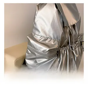 Close-up of the silver metallic backpack featuring a functional drawstring side pocket