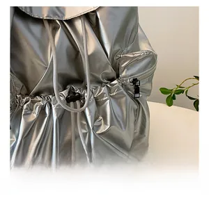 Detail of silver metallic backpack with durable drawstring closure and pleated fabric texture