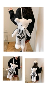 Detail of cute white bear backpack featuring a unique black skeleton pattern on PU leather