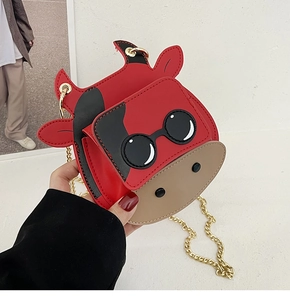 Detail of red cartoon cow mini bag featuring stylish sunglasses and golden chain strap