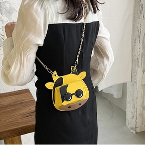 Mini yellow cow cartoon crossbody bag with sunglasses design and gold chain strap