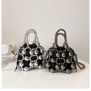 Detail of metallic bead bucket bags with mesh structure and drawstring inner lining