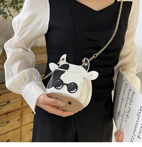 Detailed view of the cow print mini bag with sunglasses motif and gold chain strap