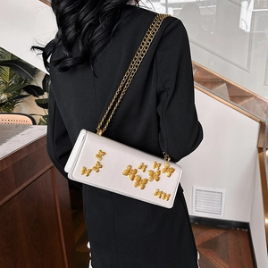 Elegant white crossbody chain bag with 3D golden butterfly accents for stylish women