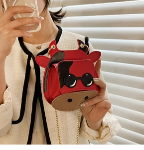 Detailed view of mini red cow crossbody bag with cute face and gold chain strap