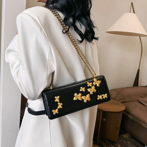 Fashionable black leather crossbody bag with 3D gold butterfly decor and chain strap