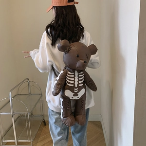 Brown teddy bear backpack with white skeleton print and gothic street style aesthetic