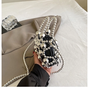Detailed view of mini bucket bag featuring silver mirrored beads and black inner drawstring