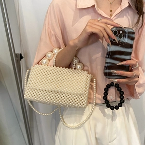 Elegant woven pearl handbag with top handle and shoulder strap for summer vacation