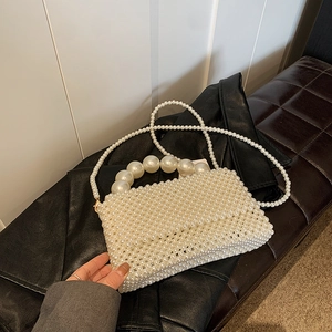 Elegant ivory pearl woven handbag with large bead handle and detachable shoulder chain