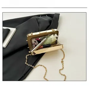 Interior view of gold metallic clutch bag showing storage for phone and lipstick