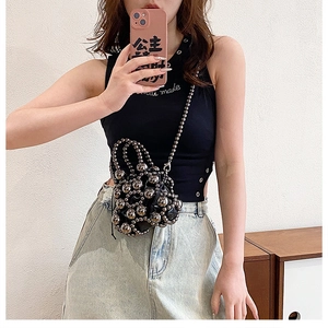 Close-up of black mini crossbody bag with silver metallic bead decor and thin chain strap
