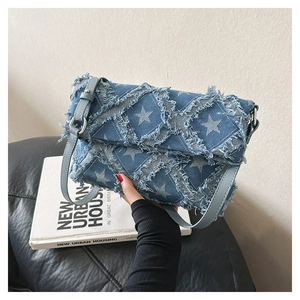 Close-up of star pattern denim fabric with quilted stitching and frayed edge detail