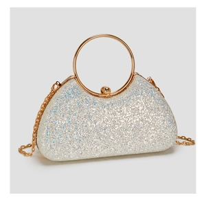 Close-up of glitter sequins evening bag with golden round handle and chain strap