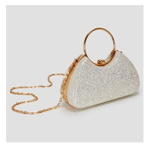 Detailed view of luxury evening clutch with white sequins and gold metal top handle