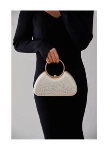 Detail of silver sequin evening clutch bag with gold round handle and spherical lock