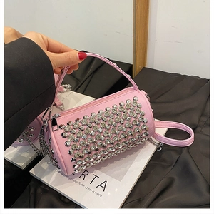 Detailed macro view of pink PU leather cylindrical bag with sparkling silver rhinestones
