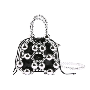Silver bead bucket bag with black drawstring liner and metallic sphere accents
