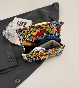 Graffiti print chain bag detail showing interior space for two phones and makeup