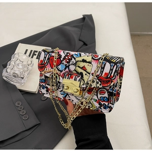 Close-up of graffiti print chain bag with pop art patterns and gold metal buckle