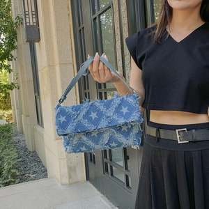 Blue denim crossbody bag with white star pattern and frayed fringe edges for women