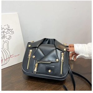 Detailed view of black motorcycle jacket crossbody bag with gold zippers and metal buttons