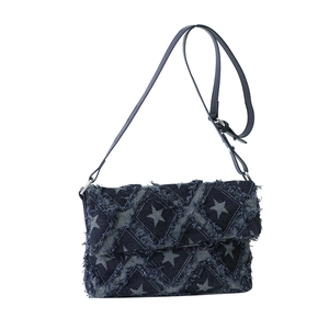 Quilted denim crossbody bag with star pattern and frayed edges in dark blue finish