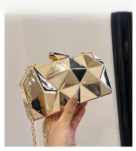 Detailed view of the 3D geometric gold mirror evening clutch bag with chain strap