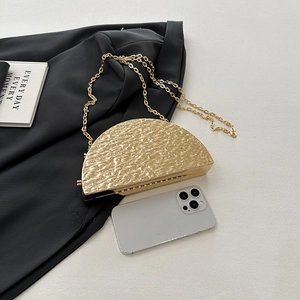Golden semicircular shell evening bag with hammered texture and fine metal chain