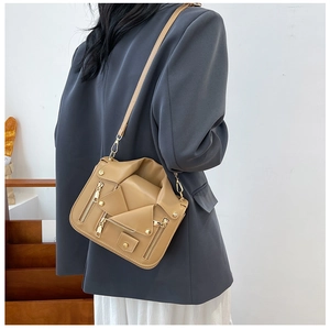 Detail of the biker jacket crossbody bag with metallic zippers and stud embellishments