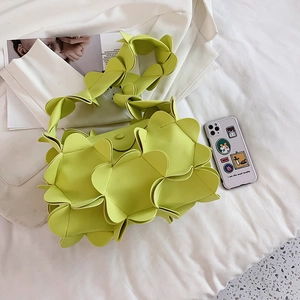 Luminous lime green petal handbag with 3D layered design and matching wide shoulder strap