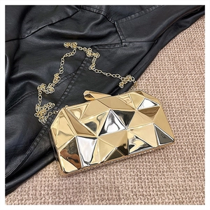 Detailed view of the gold geometric hard shell evening bag with elegant chain strap