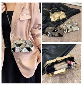 Detailed view of geometric metal evening clutch with chain strap and interior storage