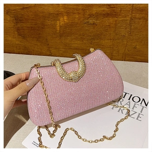 Detail of pink sequin evening bag with gold horseshoe buckle and diamond inlay