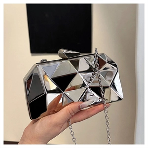 Detail of silver geometric box bag with ice-crack mirror finish and metal chain