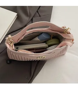 Top view of pink quilted tote bag showing spacious interior with makeup and phone
