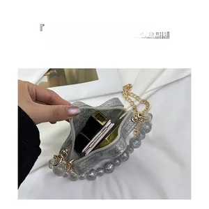 Silver sequin heart bag with pearl handle and chain strap showing interior makeup storage