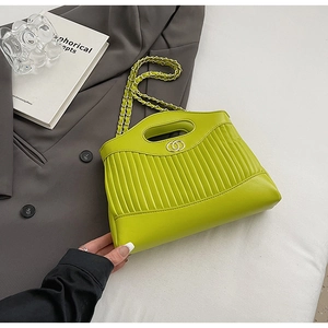 Detail of lime green pleated tote bag with gold double-ring clasp and chain strap