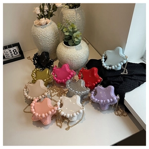 Star-shaped crossbody bags in multiple colors featuring pearl trim and gold chain straps