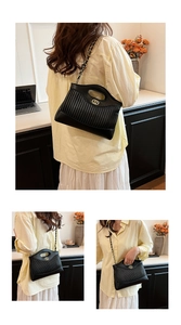 Detailed close-up showing black pleated leather bag with gold hardware and chain strap
