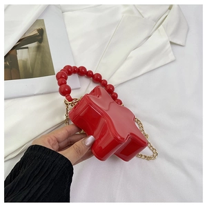Glossy red star-shaped crossbody bag with pearl top handle and golden chain strap
