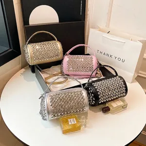 Fashionable cylinder handbag with rhinestones in multiple colors on a chic display