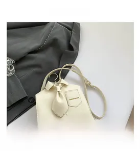 Macro shot of creative shirt-shaped PU bag featuring collar, tie, and pocket details