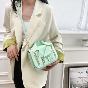 Fashionable mint green biker jacket shoulder bag with rivets and metal zippers