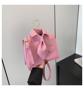 Detail of pink shirt-shaped PU crossbody bag with collar and tie decorative elements